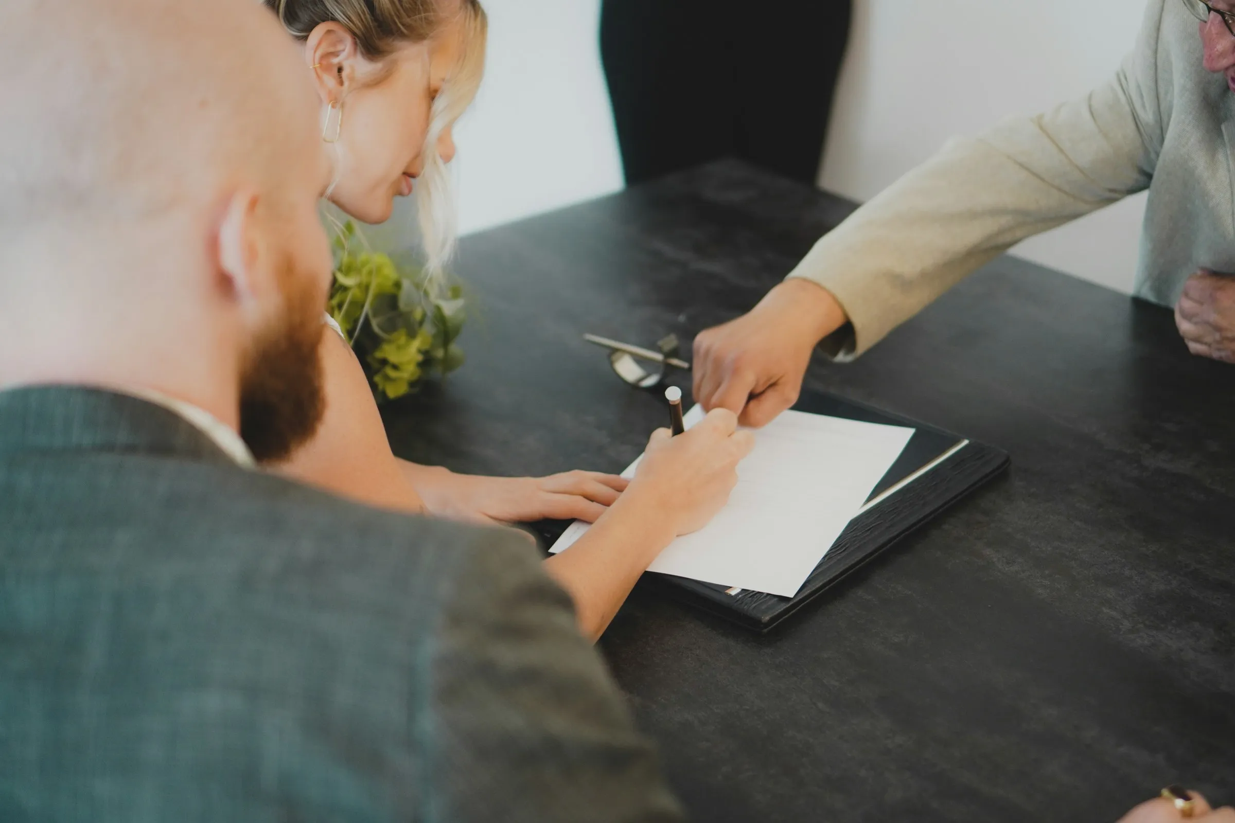 Landowners reviewing and signing closing documents at a desk